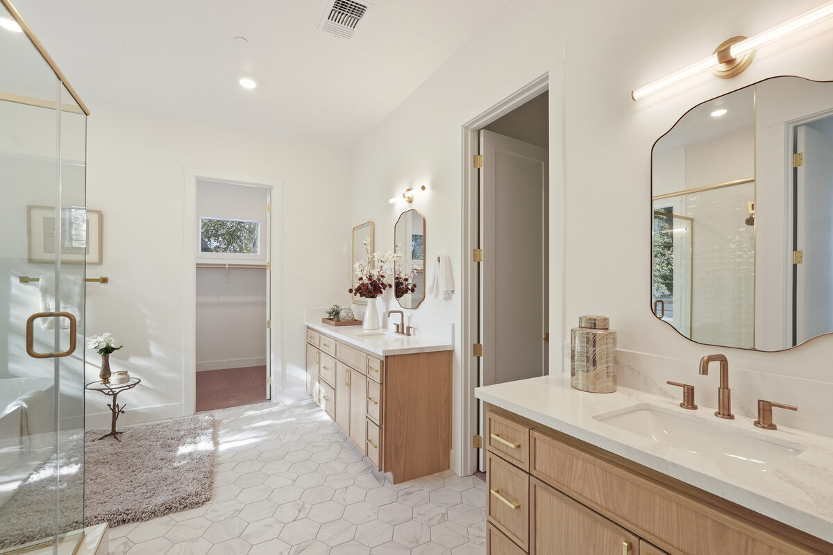 Primary bathroom with dual vanities and spa-like finishes