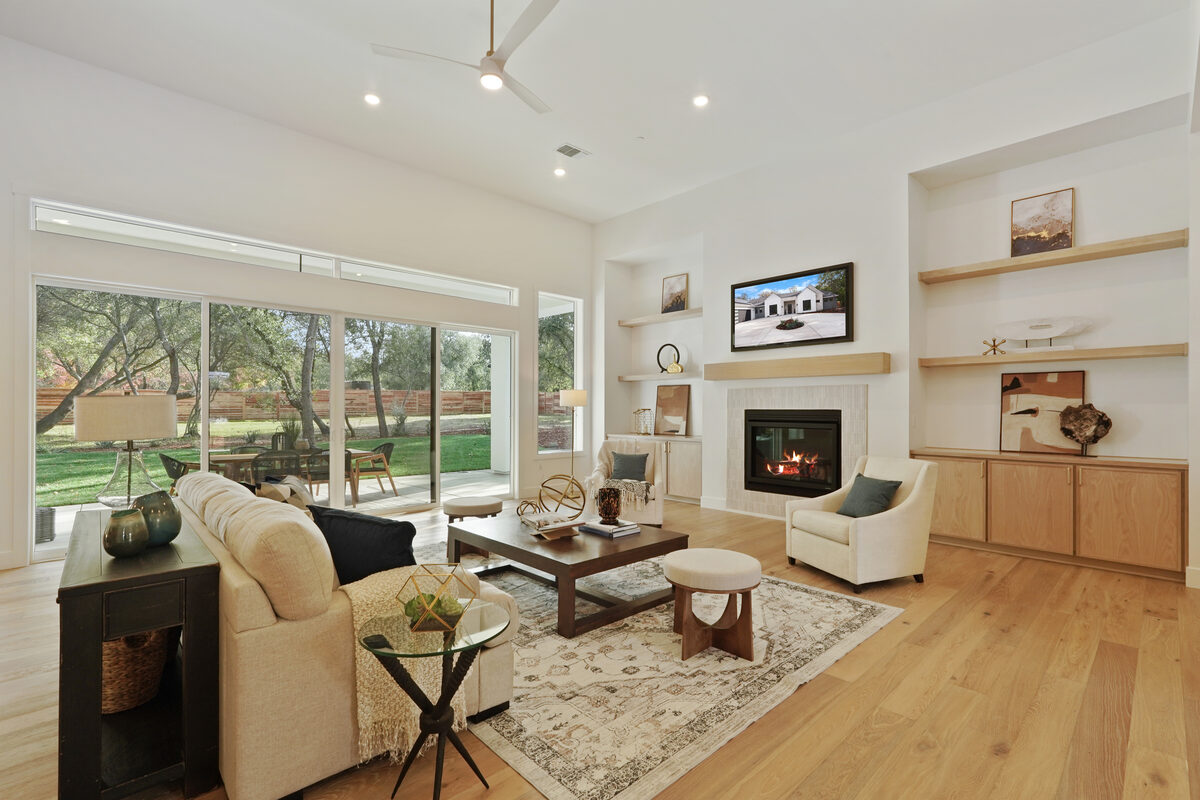 Living room with fireplace and sliding glass doors opening to backyard