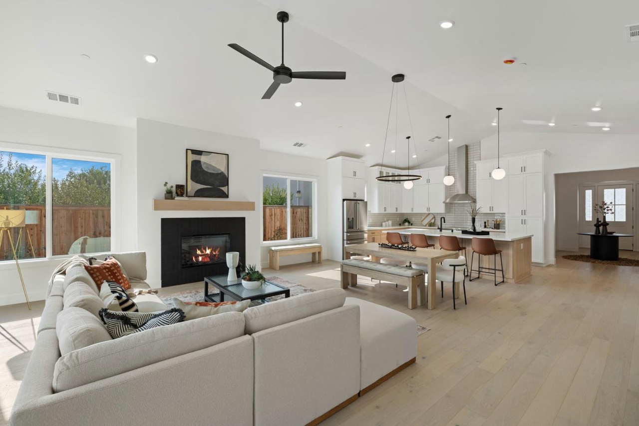 Open-concept great room with vaulted ceiling and fireplace